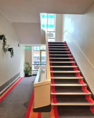 a staircase in a building with a red carpet at City Living Sentrum Hotel in Trondheim