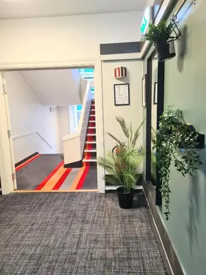 a hallway with stairs and potted plants at City Living Sentrum Hotel in Trondheim