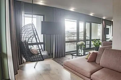 a living room with a couch and a swing at Hotel Norge by Scandic in Bergen