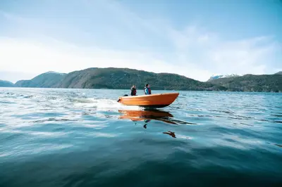 two people in a boat on the water at Ryfylke Fjordhotel in Sand
