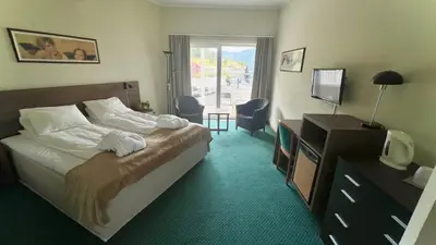 a hotel room with a bed and a television at Ryfylke Fjordhotel in Sand