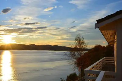 a view of a lake at sunset from a house at Langenuen Motel & Camping in Stord
