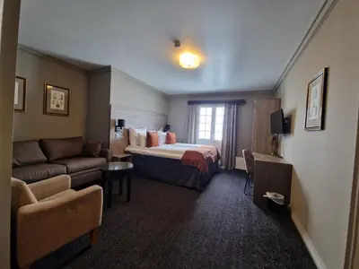 a hotel room with a bed and a couch at Dr. Holms Hotel in Geilo