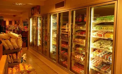 a grocery store aisle with refrigerators and lots of food at Dovre Motell in Dovre