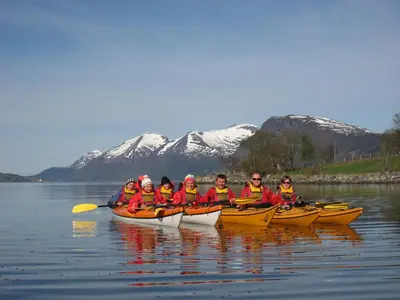 a group of people in kayaks on the water at Frich`s Hotel Surnadal in Surnadal