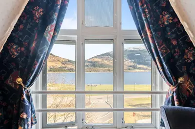a window with a view of a lake at Fleischer's Hotel in Vossevangen