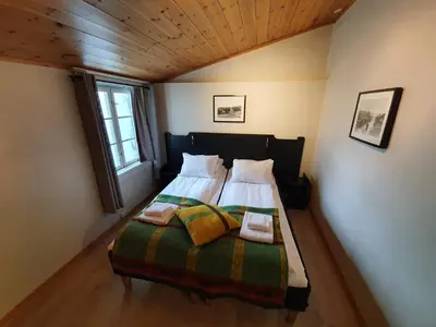 a bedroom with a bed with two pillows on it at Vertshuset Røros in Røros
