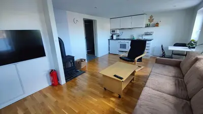 a living room with a couch and a table at Apartment Ulsteinvik in Ulsteinvik