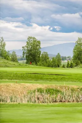 a view of a golf course with a green at Sundvolden Hotel in Sundvollen