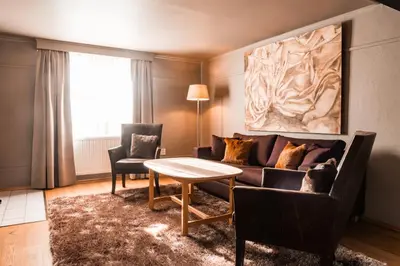 a living room with a couch and a table at Sundvolden Hotel in Sundvollen