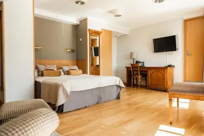 a hotel room with a bed and a desk at Sundvolden Hotel in Sundvollen