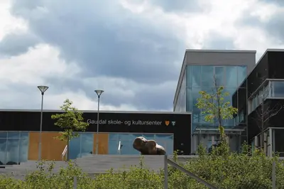 a building with a lion statue in front of it at Støren Hotel in Storen