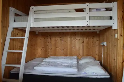 a bunk bed in a room with a ladder at Nordseter Fjellpark, Hyttegrend in Nordseter