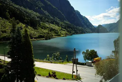 a view of a lake in the mountains at Trolltunga Hotel in Odda