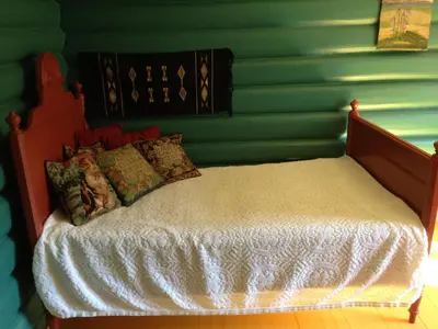 a bed in a room with a green wall at Løngdal in Tuddal