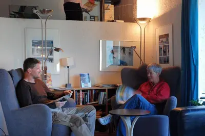 two men sitting in chairs playing a video game at Voss Vandrarheim Hostel in Vossevangen