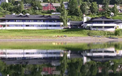 a house on the shore of a body of water at Voss Vandrarheim Hostel in Vossevangen