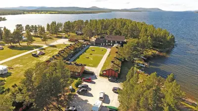 an aerial view of a house on an island in the water at Femundtunet in Drevsjø