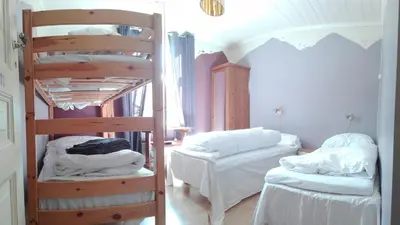 a room with two bunk beds in a room at Rongahuset BnB in Evanger