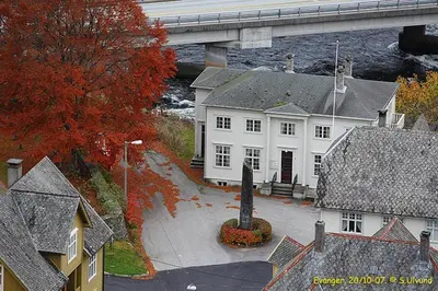 an aerial view of a white house with a bridge at Rongahuset BnB in Evanger