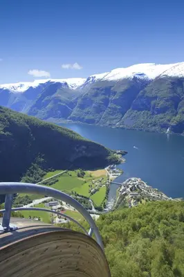 a view of a lake and snow covered mountains at Heimly Pensjonat in Flåm