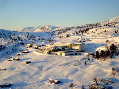 a resort in the snow on a snowy mountain at Storefjell Resort in Gol