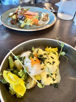 two plates of food in a bowl on a table at Brakanes Hotel in Ulvik