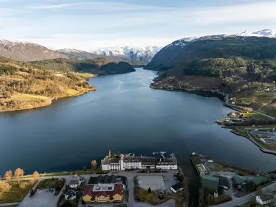 an aerial view of a lake with a castle at Brakanes Hotel in Ulvik