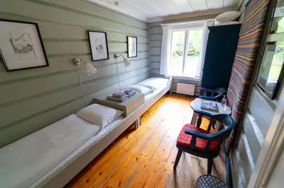 a room with a couch and a table and a window at Røisheim Hotel & Skysstasjon in Lom