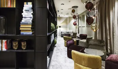 a lobby with a row of chairs and tables at Quality Hotel Grand Kristiansund in Kristiansund