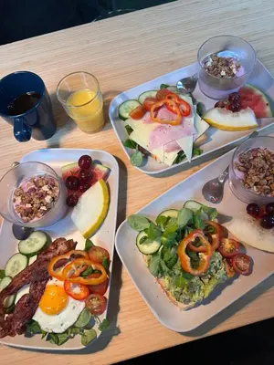 a table with three plates of food on it at Citybox Bergen City in Bergen