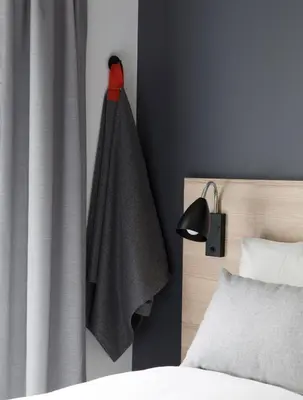 a bedroom with a bed with a towel hanging on the wall at Citybox Bergen City in Bergen