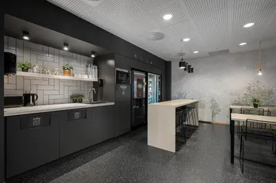 a kitchen with black cabinets and a counter top at Citybox Bergen City in Bergen