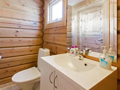 a bathroom with a white sink and a toilet at Stranda Fjellgrend in Stranda