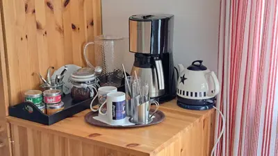a coffee maker sitting on top of a wooden shelf at Elvebakk Bed & Breakfast in Reed