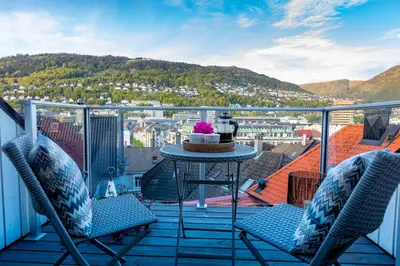 a balcony with a table and two chairs and a view at 2 Døtre Apartments by Hotel Park in Bergen