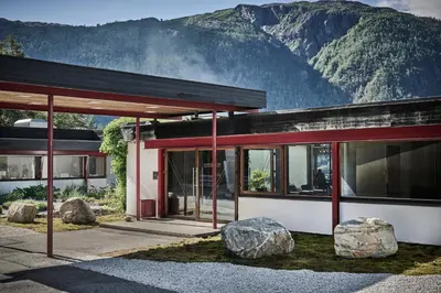 a building with two large rocks in front of it at Energihotellet in Nesflaten
