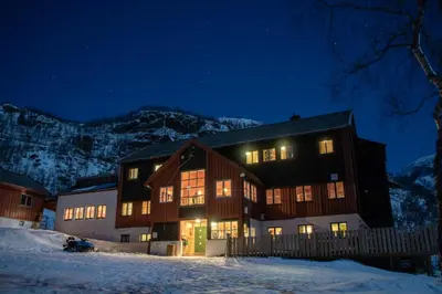 a large house at night in the snow at Voss Mountain Lodge in Mjølfjell
