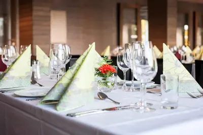 a table with wine glasses and napkins on it at Hurdalsjøen Hotel & Spa in Hurdal