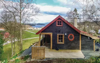 a small house with a wooden porch and a deck at Stunning Home In Førde I Hordaland in Førde