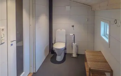a small bathroom with a toilet and a window at Stunning Home In Førde I Hordaland in Førde