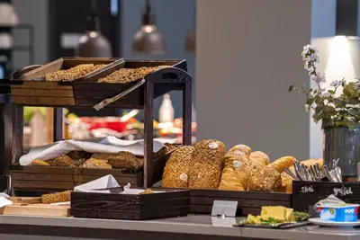 a display of bread and pastries on a table at Grand Hotel Skei - Unike Hoteller in Skei