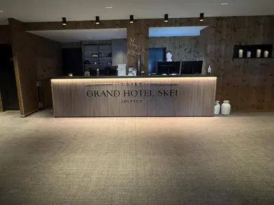 a grand hotelisel reception desk in a hotel room at Grand Hotel Skei - Unike Hoteller in Skei