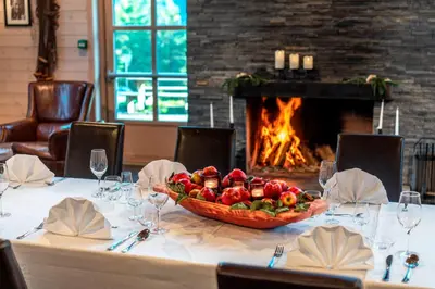 a table with a bowl of fruit and a fireplace at Thon Hotel Bjørneparken in Flå