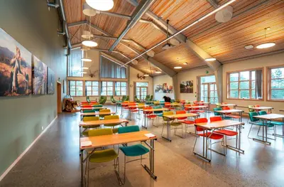 a classroom with tables and chairs in a building at Thon Hotel Bjørneparken in Flå