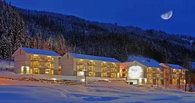 a hotel in the snow at night at Nermo Hotel & Apartments in Hafjell