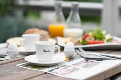 a table with two cups and a plate of food at Nermo Hotel & Apartments in Hafjell