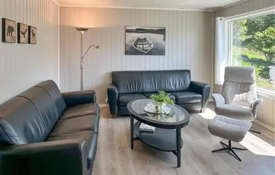 a living room with a couch and a table at 5 Bedroom Awesome Home In Etne in Erve