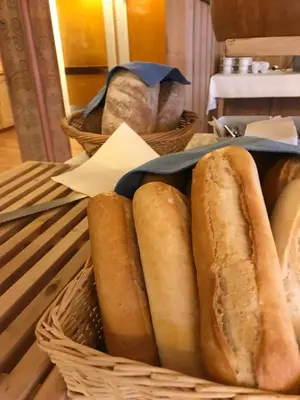 a basket of bread sitting on a table at Øigardseter Fjellstue in Høvringen