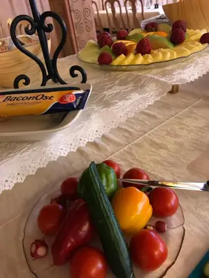 a plate of fruit and vegetables on a table at Øigardseter Fjellstue in Høvringen